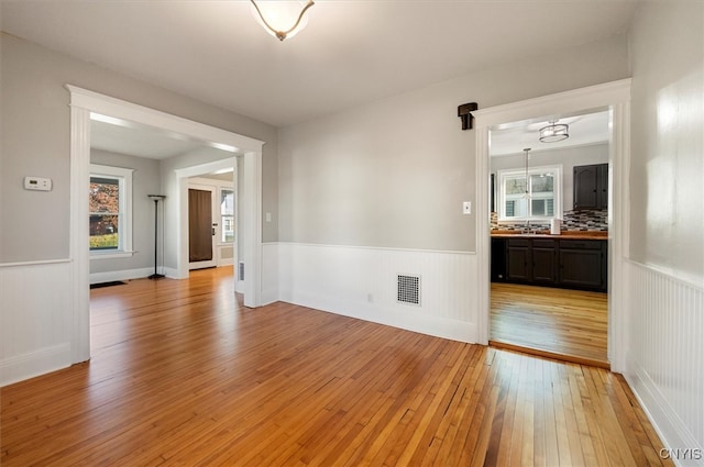 spare room with light wood-type flooring and sink