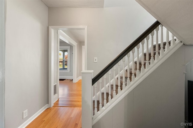 stairs featuring wood-type flooring