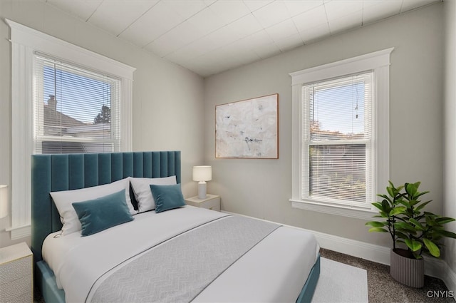 carpeted bedroom featuring multiple windows