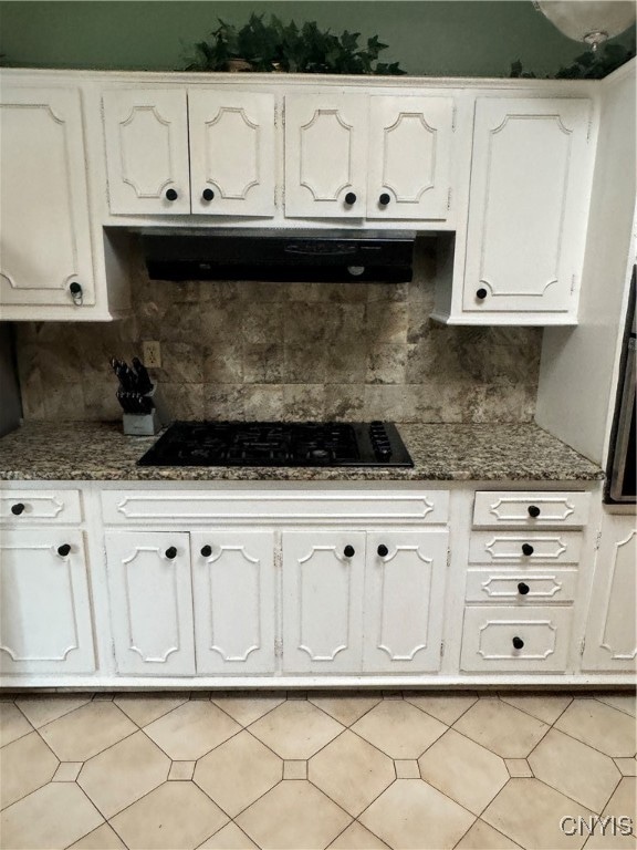 kitchen with white cabinetry, extractor fan, black gas cooktop, and tasteful backsplash