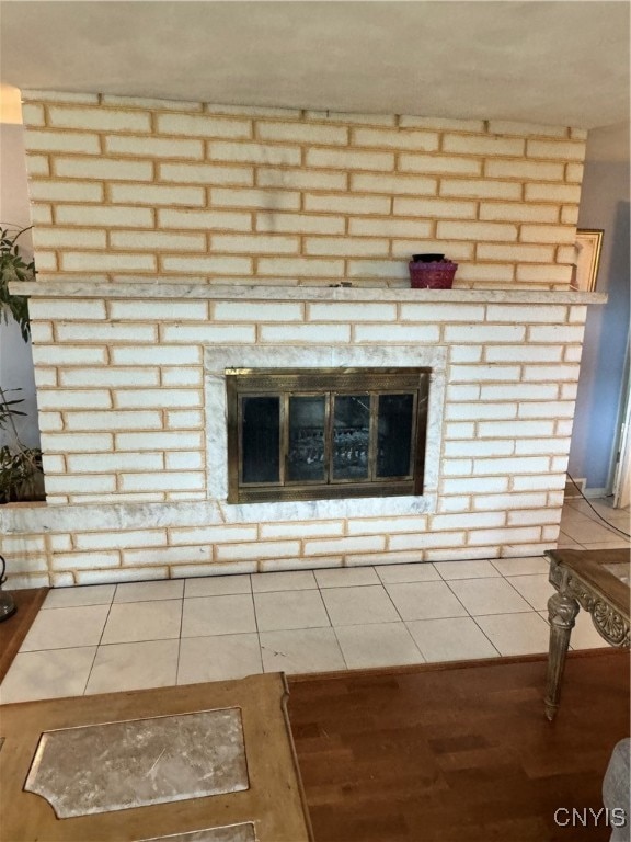 room details featuring tile patterned floors and a brick fireplace