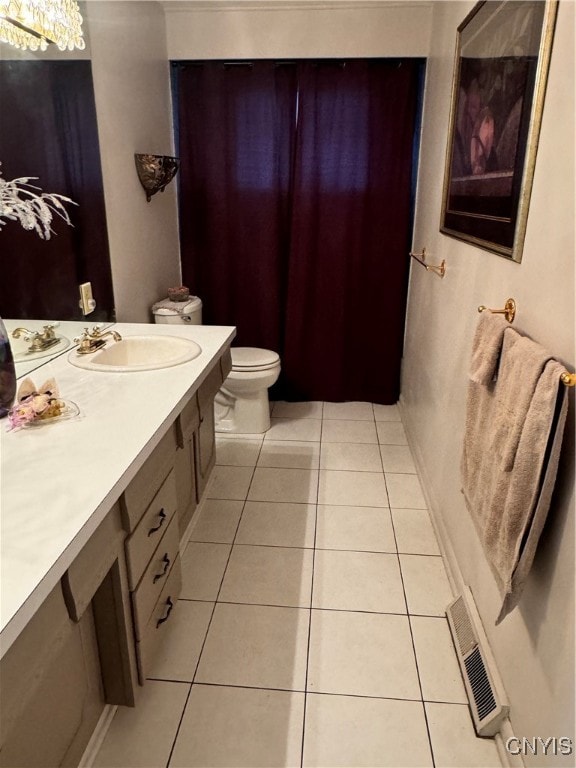 bathroom featuring tile patterned flooring, vanity, and toilet