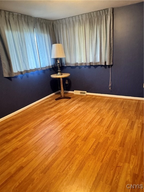 spare room with wood-type flooring