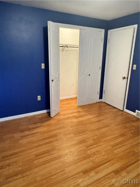 unfurnished bedroom featuring light wood-type flooring