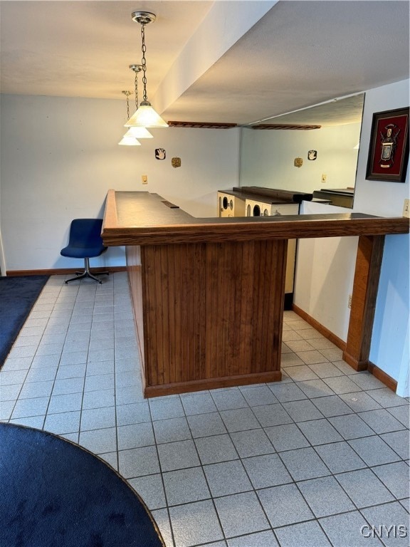 kitchen with light tile patterned floors and decorative light fixtures