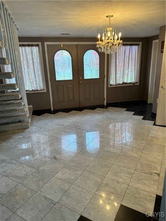 foyer with a chandelier