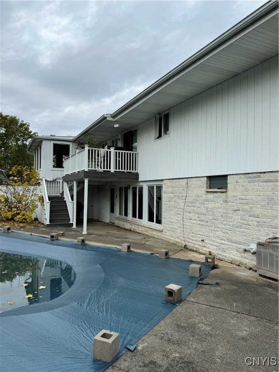 exterior space with central air condition unit, a patio area, and a swimming pool side deck