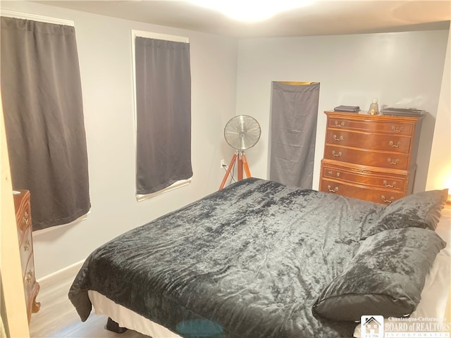 bedroom with hardwood / wood-style flooring