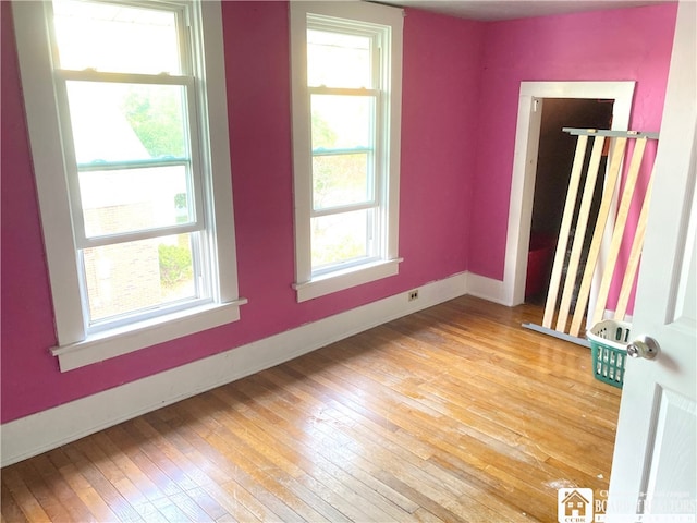 unfurnished room with a wealth of natural light and light wood-type flooring