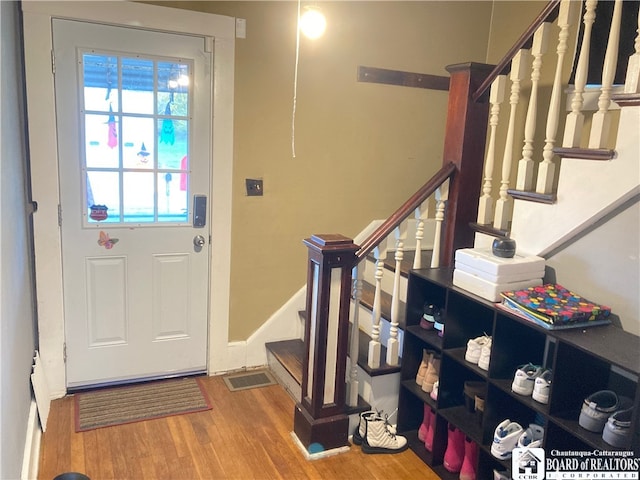 entryway with hardwood / wood-style floors