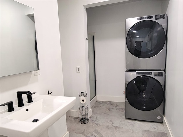 laundry area featuring sink and stacked washer and clothes dryer