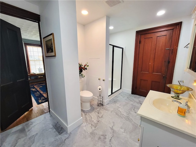 bathroom with vanity, toilet, walk in shower, and hardwood / wood-style floors