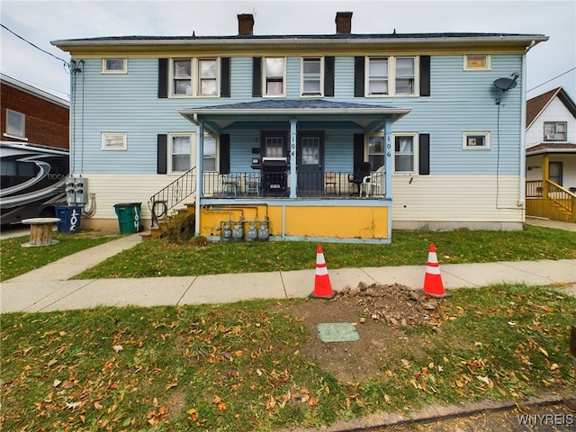 106 Esser Ave, Buffalo, NY 14207 - townhome / multi-family property with covered porch, a chimney, and a front yard