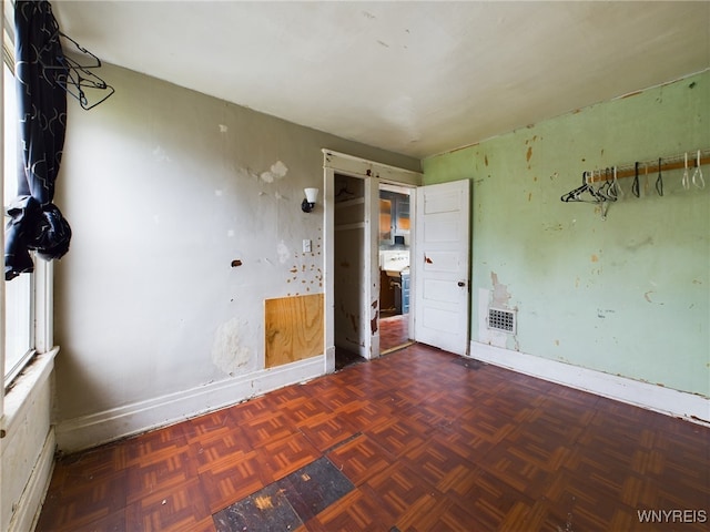 unfurnished room featuring parquet flooring