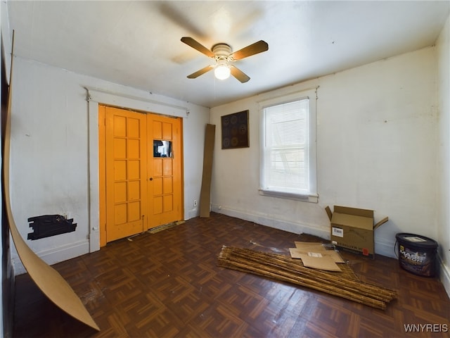 foyer featuring dark parquet flooring and ceiling fan