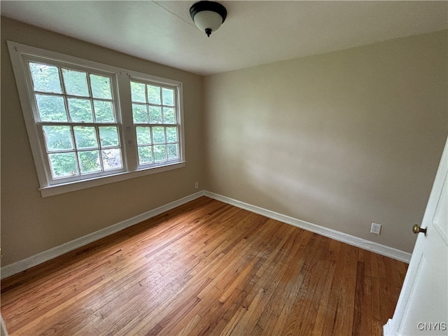 unfurnished room with light wood-type flooring