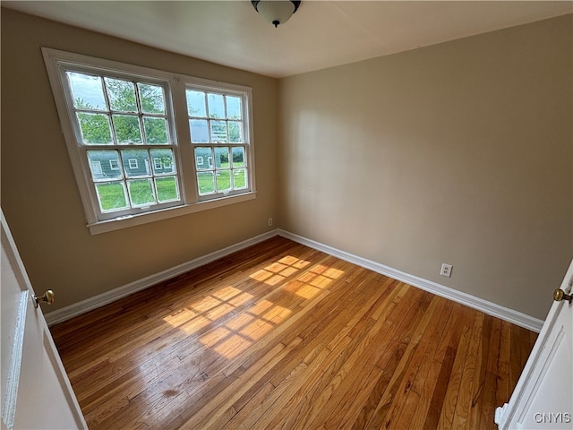 empty room with hardwood / wood-style flooring