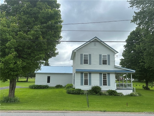 view of front of home with covered porch and a front lawn