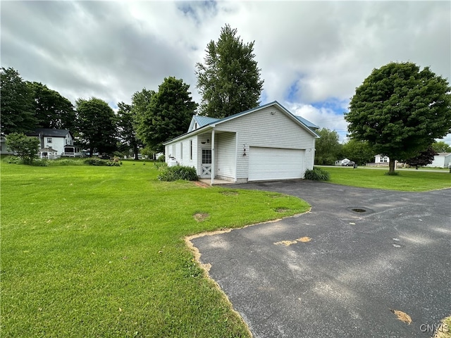 view of property exterior featuring a yard and a garage