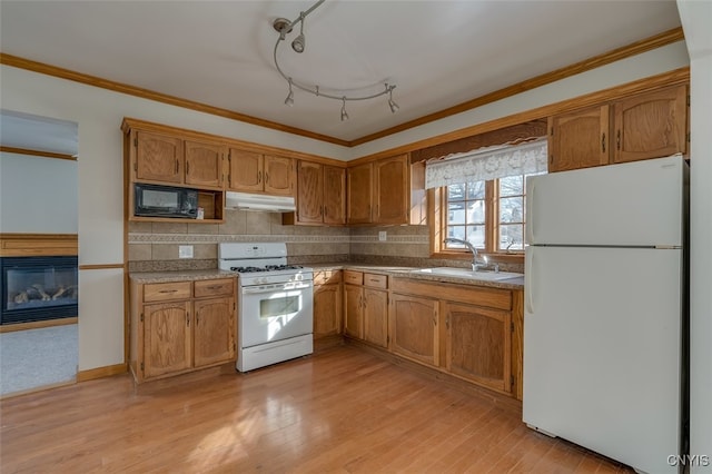 kitchen with white appliances, sink, backsplash, ornamental molding, and light hardwood / wood-style flooring