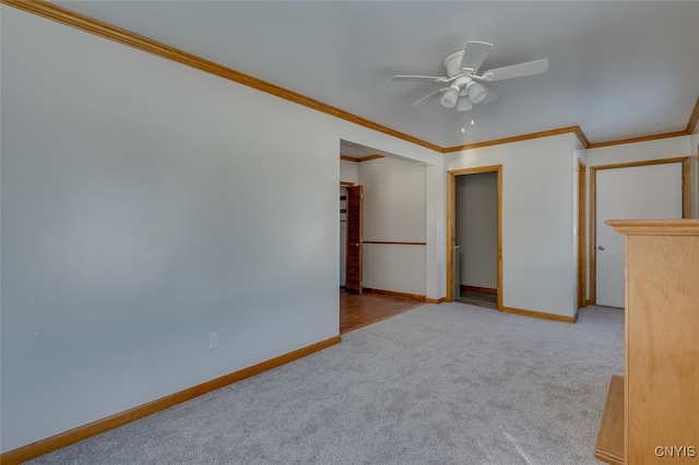 carpeted empty room with ornamental molding and ceiling fan