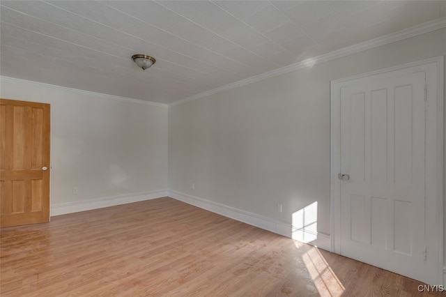 spare room with light hardwood / wood-style floors and crown molding