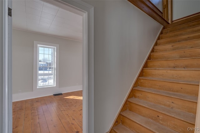 stairway featuring hardwood / wood-style floors