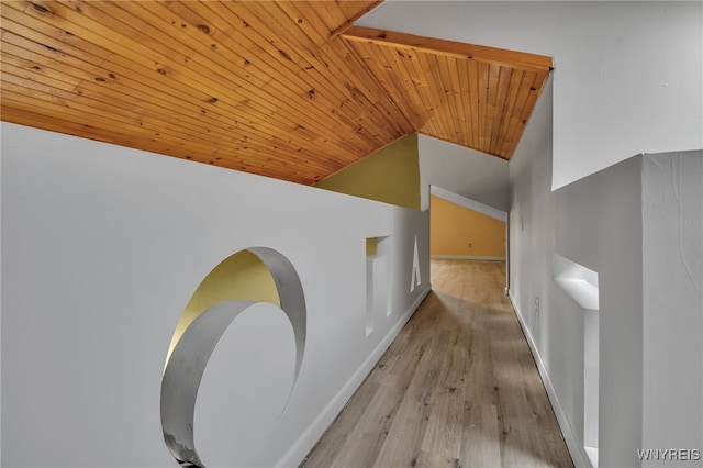 hallway featuring wood ceiling, light wood-type flooring, and vaulted ceiling