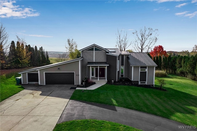 view of front of home with a garage and a front lawn