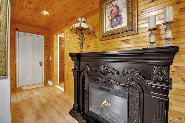 interior details with wood ceiling, wooden walls, and hardwood / wood-style floors