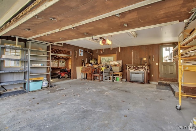 interior space with wood walls and a garage door opener