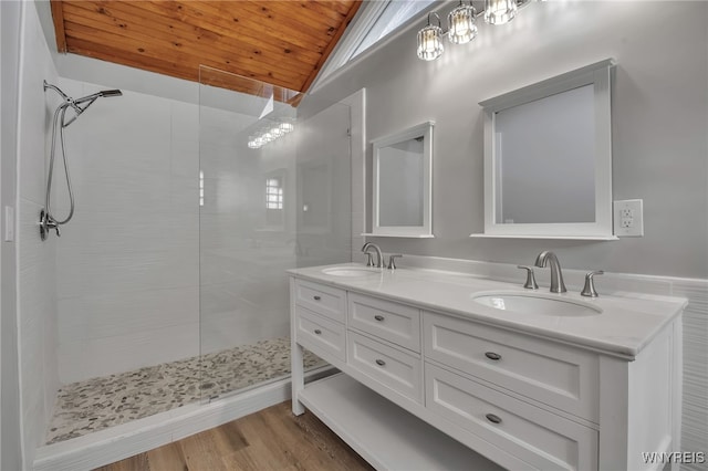 bathroom featuring tiled shower, wood ceiling, wood-type flooring, vaulted ceiling, and vanity