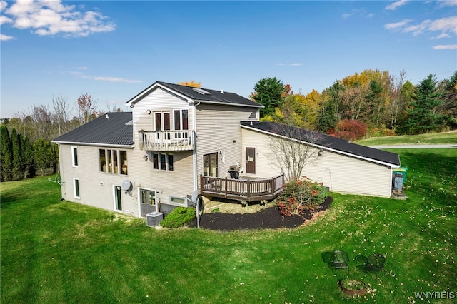 rear view of property featuring cooling unit, a deck, a lawn, and a balcony