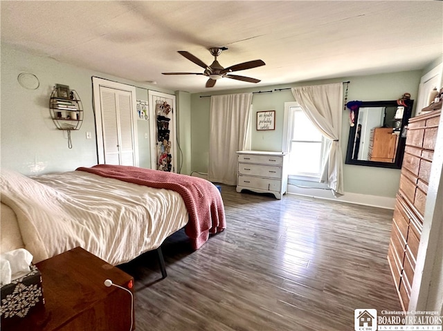 bedroom with dark hardwood / wood-style flooring and ceiling fan