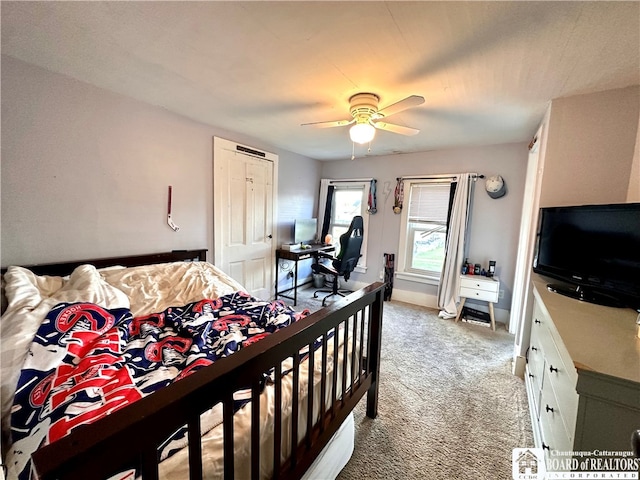 carpeted bedroom featuring a closet and ceiling fan