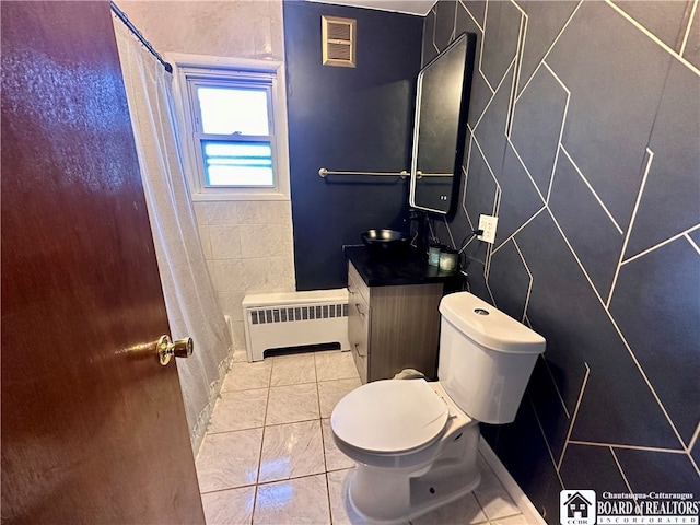 bathroom with vanity, radiator heating unit, toilet, and tile patterned flooring