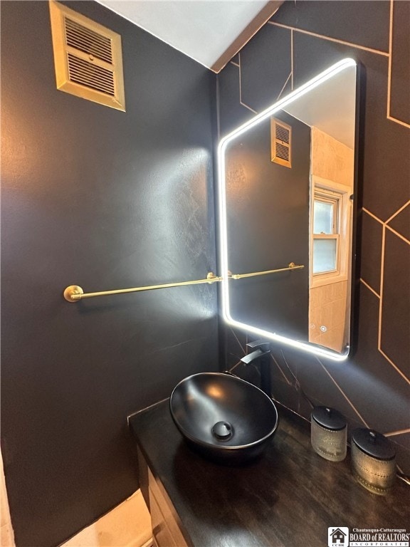 bathroom with vanity, tile walls, and backsplash