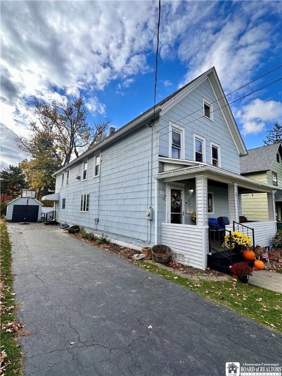 view of side of home featuring a shed