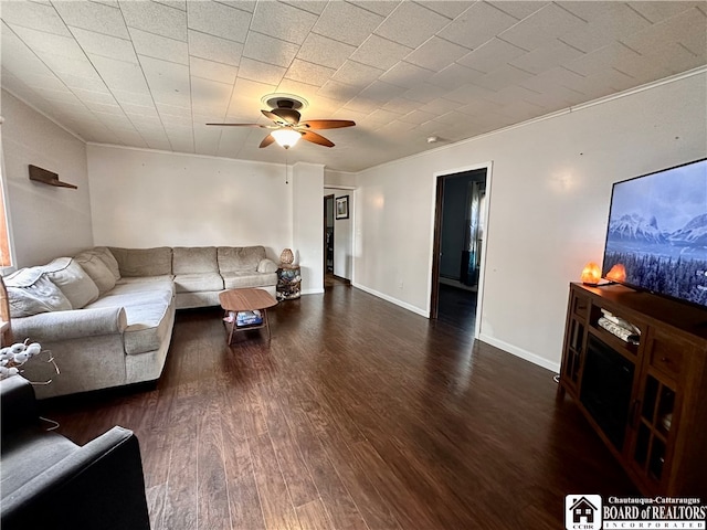 living room featuring crown molding, dark hardwood / wood-style floors, and ceiling fan