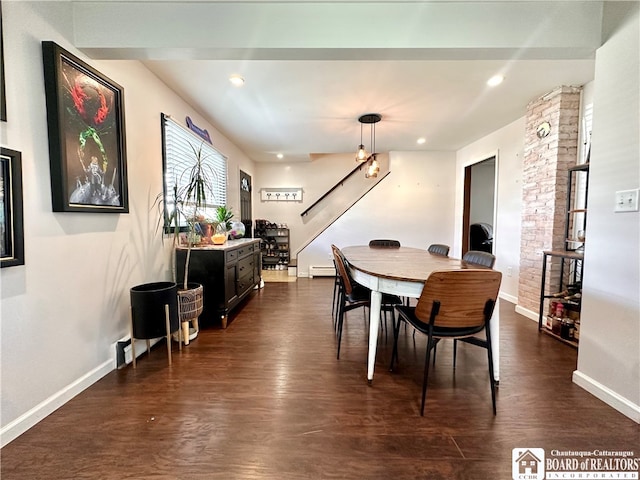 dining area with a baseboard heating unit and dark wood-type flooring