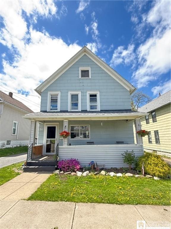 311 Nevins St, Dunkirk-City, NY 14048 - american foursquare style home featuring a porch and a front yard