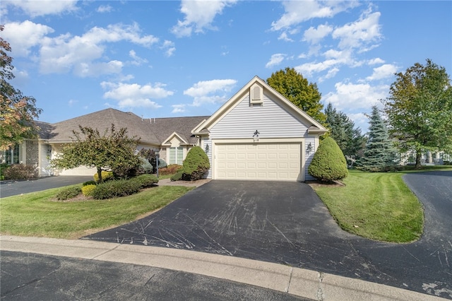 view of front of house with a front yard and a garage