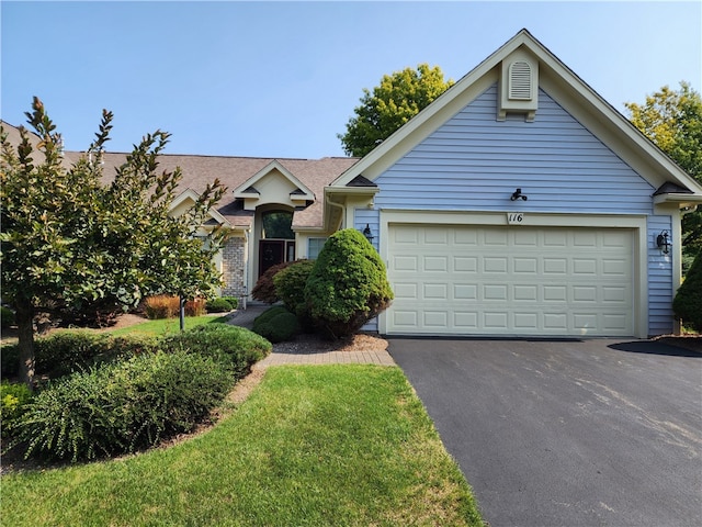 view of front of home featuring a front yard and a garage