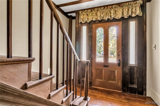 entrance foyer with beamed ceiling and wood-type flooring