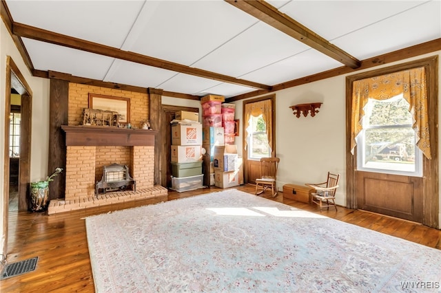 unfurnished living room featuring hardwood / wood-style flooring and a wood stove