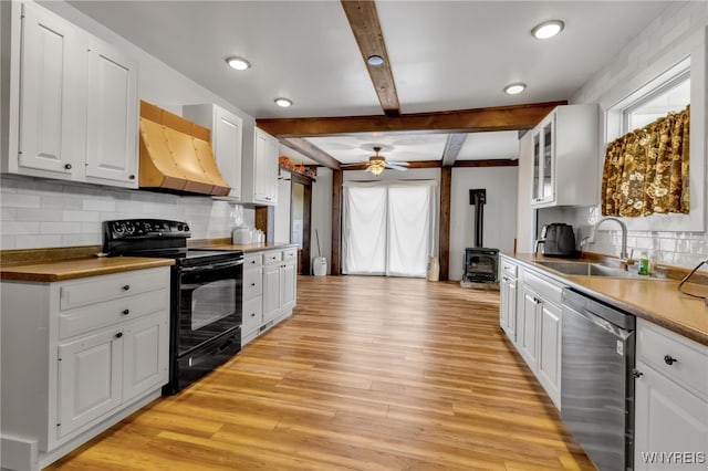 kitchen featuring exhaust hood, black / electric stove, stainless steel dishwasher, white cabinets, and light hardwood / wood-style floors