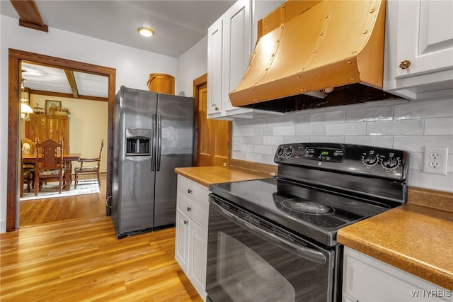 kitchen featuring backsplash, white cabinetry, light hardwood / wood-style floors, black / electric stove, and stainless steel fridge with ice dispenser