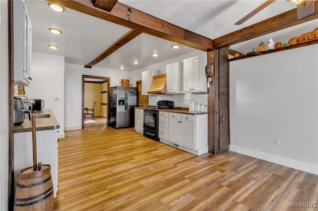 kitchen featuring white cabinets, beam ceiling, stainless steel fridge with ice dispenser, black electric range, and light hardwood / wood-style floors