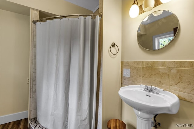 bathroom featuring a shower with shower curtain and hardwood / wood-style flooring