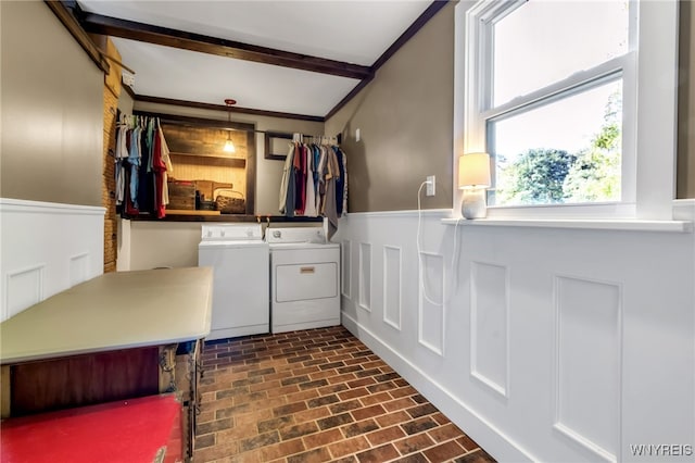 washroom with ornamental molding and separate washer and dryer